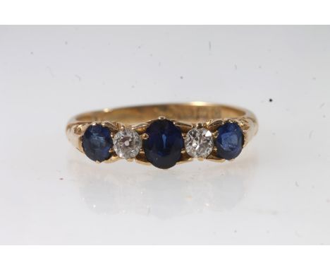 c1930s 18ct gold sapphire and diamond five stone ring, the oval cut sapphires and round cut diamonds claw set on a scrolled m