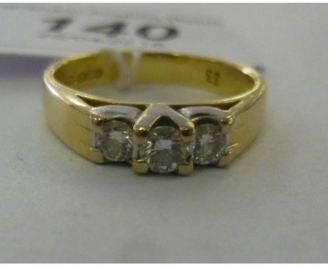 An 18ct gold ring, set with three in-line diamonds         11