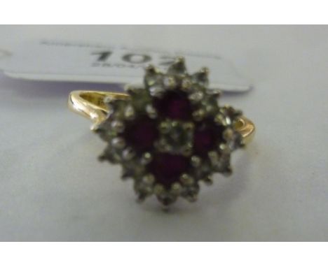 An 18ct gold ruby and diamond set, three tier cluster ring         11