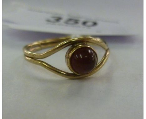 A 9ct gold ring, set with a red cabochon       11