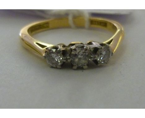 An 18ct gold ring, claw set with three in-line diamonds        11