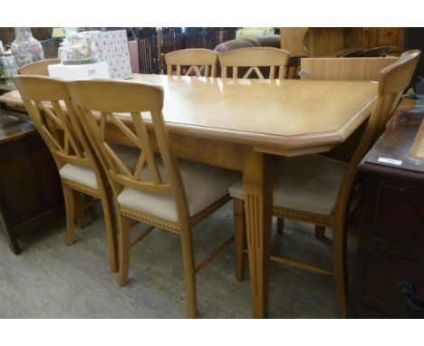 A modern light oak extending dining table, the top having canted corners, raised on square, tapered, fluted legs  30''h  56''