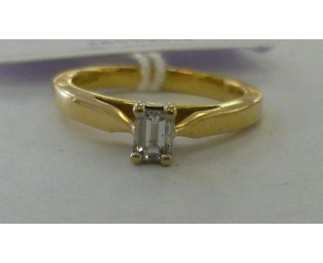 An 18ct gold single baguette cut diamond solitaire ring           11