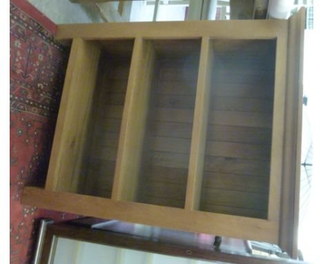 A modern light oak finished, open front bookcase, raised on extended stile feet  33''h  27.5''w        LAF