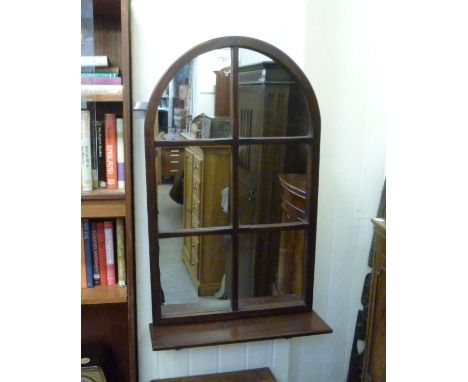 A modern Juckes mirror, the segmented plate set in an arched mahogany frame, incorporating a base shelf  36'' x 22''         