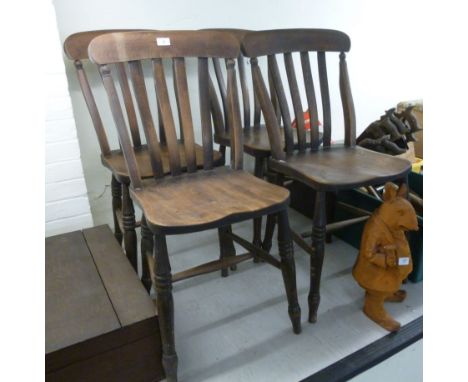 A set of four early 20thC beech framed lath back Windsor style chairs, the solid seats raised on ring turned legs       BSR