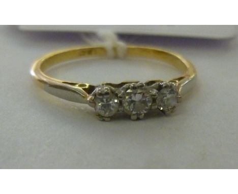 An 18ct bi-coloured gold ring, set with three in-line diamonds           11