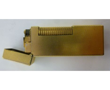 A gold plated cased Dunhill lighter, having engine turned decoration         11