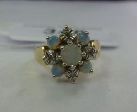 A 9ct gold ring, set with opals and diamonds       11