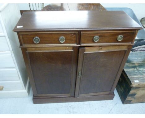 A 20thC mahogany sideboard, having two in-line drawers with ring handles, over a pair of panelled doors, on a plinth  38''h  