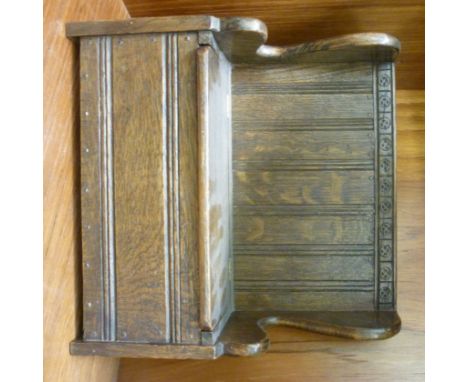 A 1930s miniature oak high back settle, having a hinged seat, on a bracket plinth  9''h  9''w       RSF