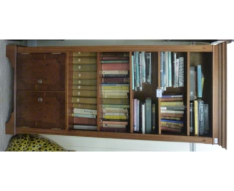 A modern yew finished cabinet bookcase, having a dentil moulded cornice, over three height adjustable shelves and a panelled 