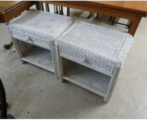 A pair of modern white painted, woven cane bedside tables, each having a frieze drawer, above an open shelf  21''h  22''w    