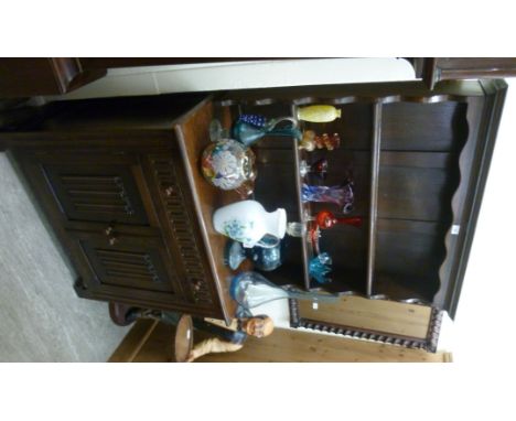 A modern oak Welsh dresser, having a two tier plate rack, over a drawer and two panelled doors with linenfold ornament, raise