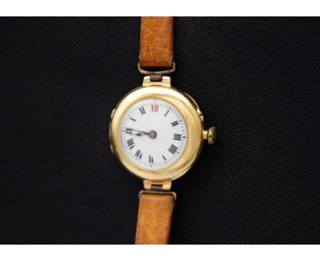 An early 20th century 18ct cased lady's manual wind wristwatch. The white enamel dial with Roman numerals, Swiss cylinder mov