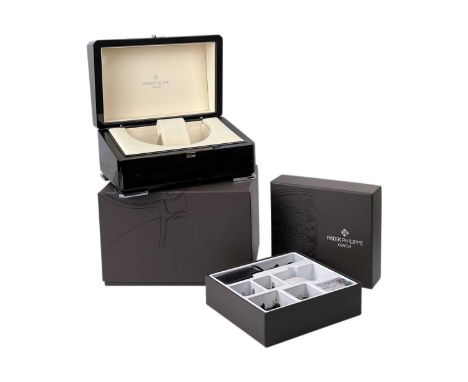 PATEK PHILIPPE - A motorized watch winder box. With inner brown felt box dust sleeve, the hinges with repair, outer cardboard