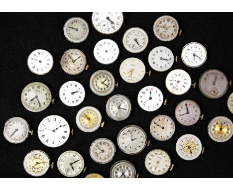 A quantity of mid-sized circular manual wind wristwatch movements and dials for repairs and spares. Early to mid 20th century