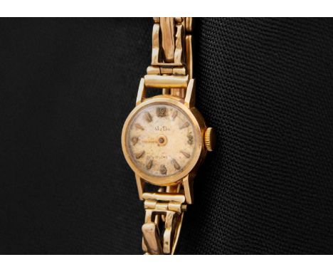 A MuDu 18ct cased lady's manual wind watch with 9ct expanding bracelet. With 13mm dial, 17 jewel movement, case stamped 18k 0