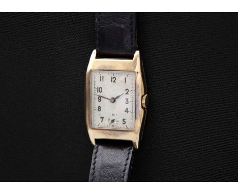 BRAVINGTONS - A Renown 1930's 9ct tonneau case manual wind gentleman's wristwatch. The 18mm rectangular silvered dial with bl