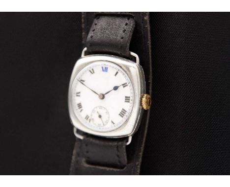 A 1920's silver cushion-cased gentleman's fixed lug wristwatch. The white enamel dial with black Roman numerals and blue X11 
