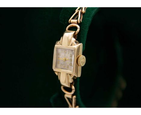 ROLEX - A 9ct lady's manual wind bracelet wristwatch. The signed silvered dial with gilt Arabic numerals, signed 17 jewel mov