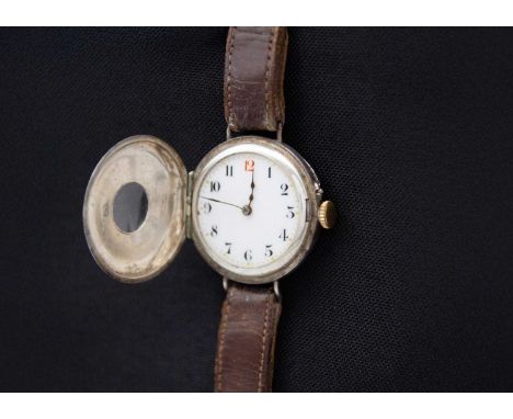An early 20th century silver cased half hunter Swiss cylinder lug wristwatch. The white enamel dial with black and red Arabic