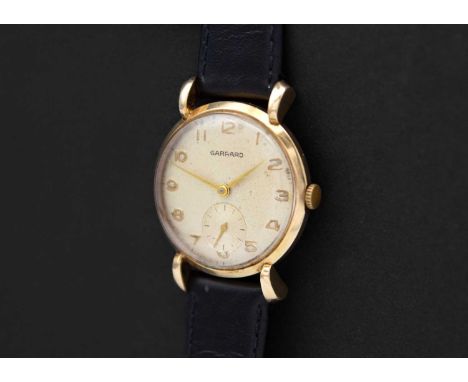 GARRARD - A 1950's 9ct cased gentleman's manual wind wristwatch. The signed 29mm silvered dial with gilt Arabic numerals and 