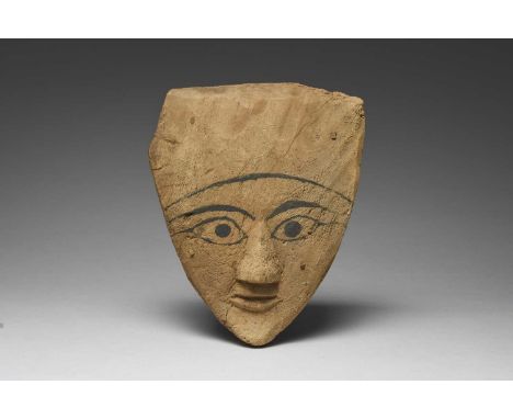 An Egyptian sarcophagus maskLate Period, circa 664 - 332 BCwith painted eyes, brows and forehead arch and with four pegs,33cm