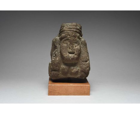 An Aztec bust of Chalchiuhtlicue Mexico, circa 1345 - 1521 AD basalt, carved with a banded headdress tied at the back and wit