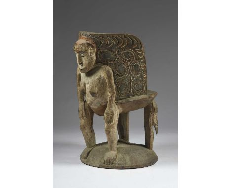 An Iatmul orator's stoolPapua New Guineathe curved back with carved stylised decoration and with a standing female figure wit