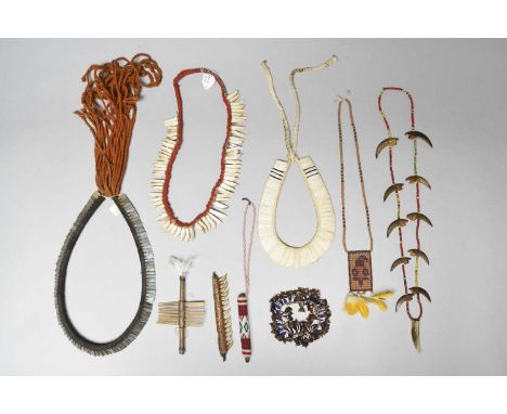 Four Amazon necklacesBrazilincluding two with peccary teeth and fibre, the smaller with red cloth, 37cm and 54cm long, two wi