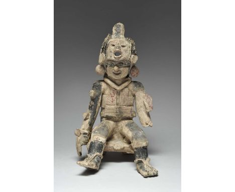 A Veracruz seated warriorMexico, circa 600 - 900 ADpottery, wearing a mask headdress, disc ear ornaments, a necklace, chest a