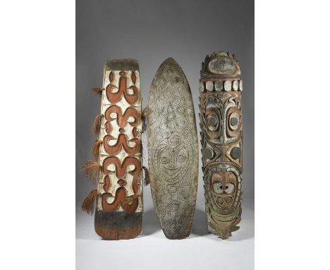 A large Iatmul ceremonial house panelPapua New Guineacarved as a elongated mask, with large eyes, nose and protruding tongue,