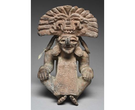 A Zapotec figure urnMexico, circa 500 - 800 ADpottery, depicting Cocijo, seated wearing an ornate headdress, ear ornaments an