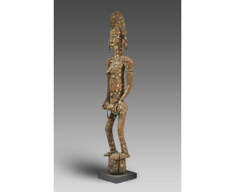 A Senufo maternity figureIvory Coaststanding with a child strapped to her back and holding a younger child below her navel, w