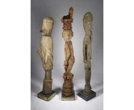 A Dayak hampatong figureIndonesiathe standing male with his head turned to his left, with large eliptical eyes and carved tee