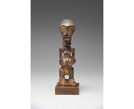 A Songye male power figureDemocratic Republic of the Congowith an aperture to the top of the head, a ringed neck and with his