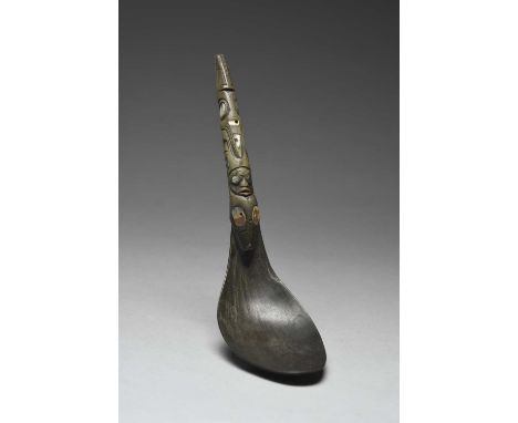 A Haida spoonBritish Coumbia, Canada horn with abalone shell inlay, the handle carved with a human face and stylised animals,
