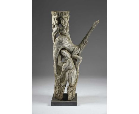 An Indonesian carved trunk sculpturedepicting figures, a crocodile and dog like animals, with white and black painted decorat
