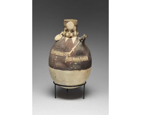 A Chancay figural vesselPeru, circa 1100 - 1450 ADpottery, with applied ear and forehead discs and a tethered dog on the shou