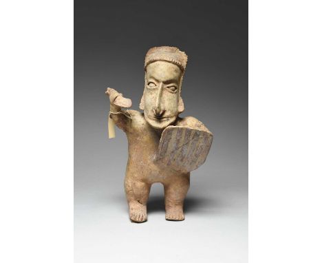A Jalisco standing figure of a warriorMexico, circa 100 BC - 250 ADwearing a banded headdress and with disc adornments to the
