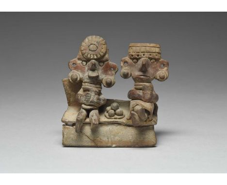 A Colima coupleMexicopottery, sitting on a bench wearing headdresses and ear ornaments, the male with a nose ornament, both h