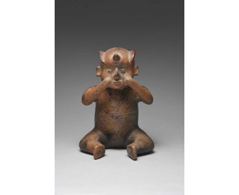 A Colima seated figure vesselMexico, circa 100 BC - 250 ADpottery, with a side fin and horn coiffure, a spout to the back of 