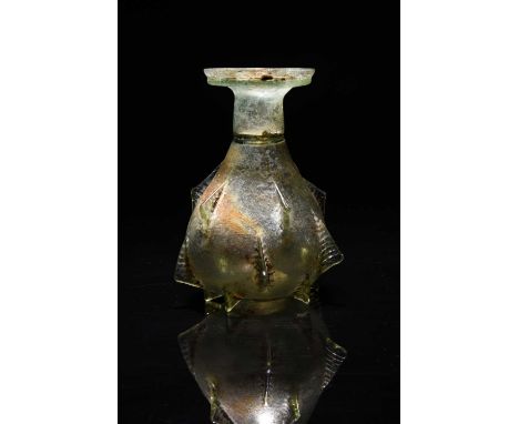 A Roman pale green glass sprinkler flask circa 2nd - 3rd century AD the pear shape body with fifteen ribbed fins in three sec