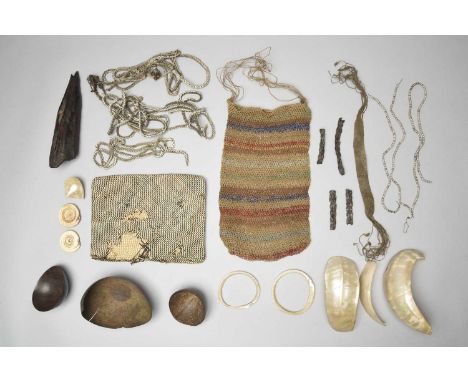 A collection of Melanesian artefactsshell, boars' tusks, fibre, nut cases and beads, including an Asmat nose ornament, 19cm w