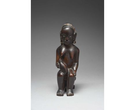 A Kamba seated maternity figureKenyawith a child in a carrier on her back and with a flask in her lap, both with inset stone 