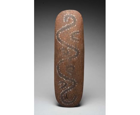 An Aboriginal shieldNorthern Territory, Australiawith a carved channelled surface and integral handle, with an all-over red p
