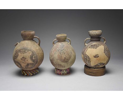 Three Chancay vesselsPeru, circa 1100 - 1450 ADpottery, one moon flask type with relief masks to the rim, a pair of handles a