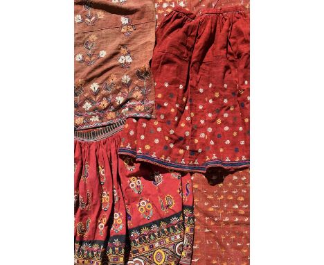 Two Indian embroidered skirtscotton, one decorated with peacocks and foliage with mirrors, the other with flowerheads,82cm lo