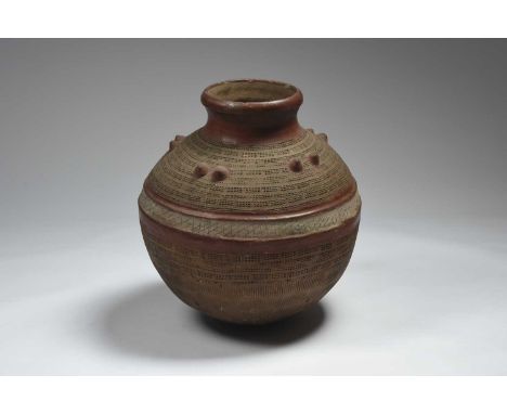 A large Nigerian vessel pottery, spherical with five pairs of mounds to the shoulders and with impressed and incised decorati